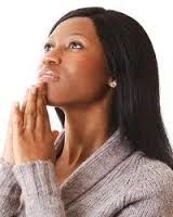 Woman praying with hands folded in prayer